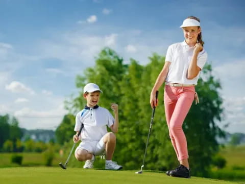 a woman and a man playing golf