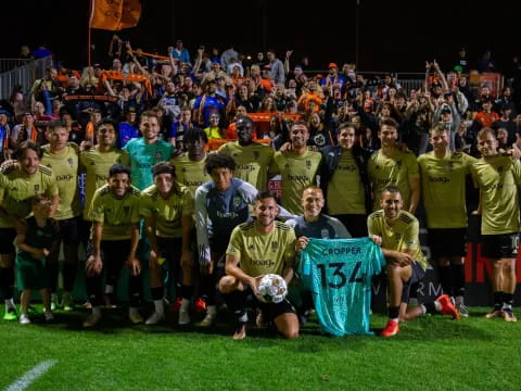 a group of football players posing for a photo