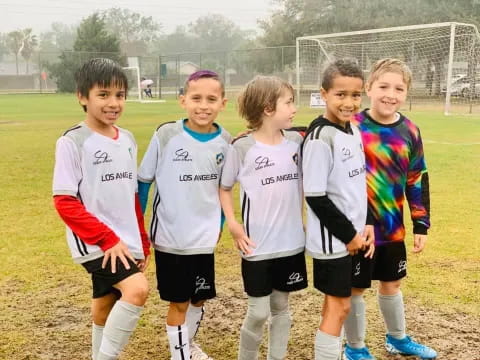 a group of kids in football uniforms
