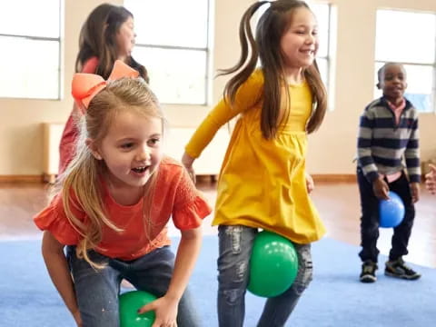 a group of children playing with balls