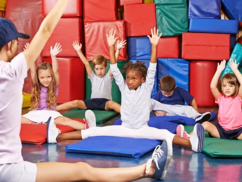 a group of children sitting on mats