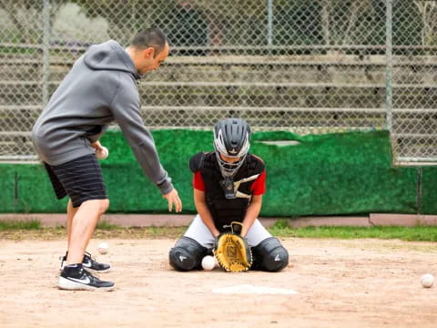 a person and a boy playing baseball