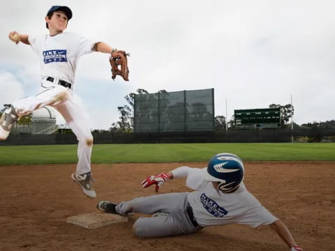 a baseball player sliding into a base