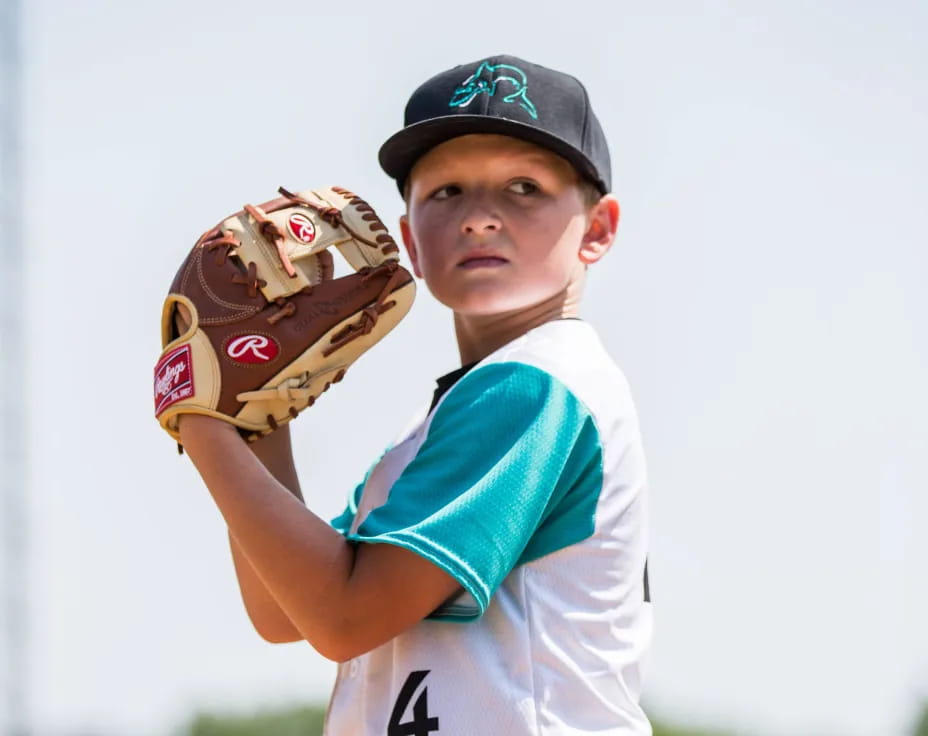 a boy wearing a baseball glove
