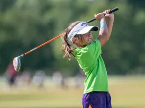 a person swinging a golf club