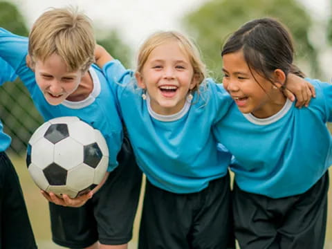 a group of kids playing football