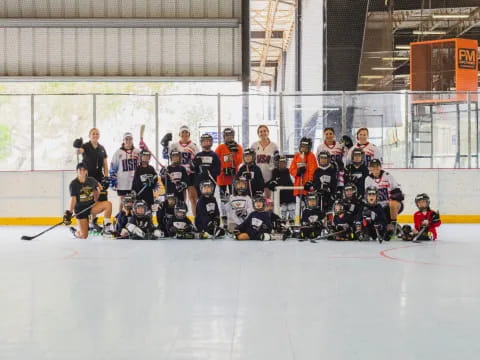 a group of people posing for a photo on an ice rink