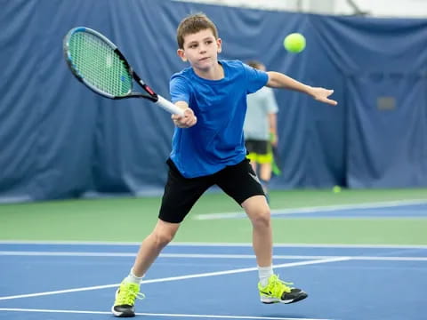 a boy playing tennis