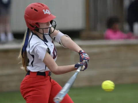 a young girl playing baseball