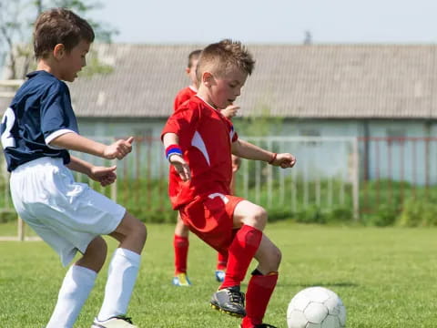 a couple of young boys playing football