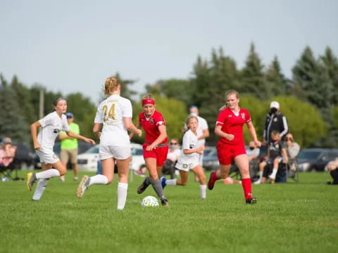 girls playing football on a field