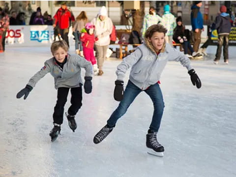 a couple of people ice skating