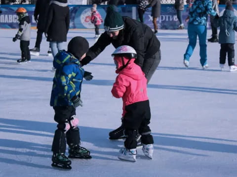 a person and two children ice skating