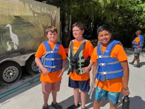 a group of boys wearing vests