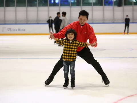 a person and a boy ice skating