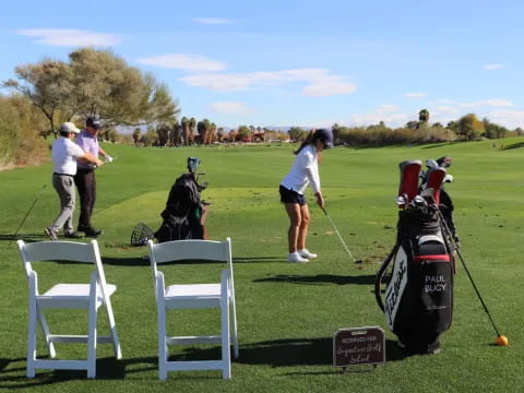 a group of people playing golf