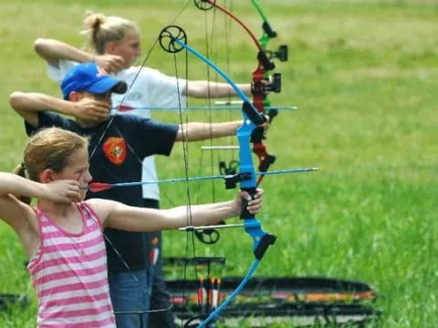a group of people shooting bows
