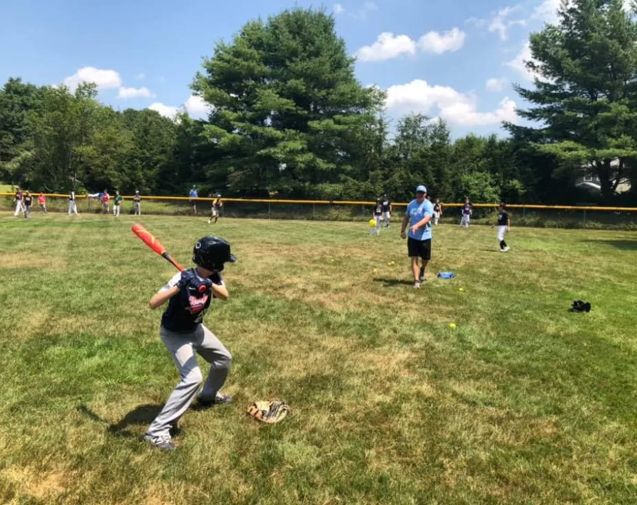 a kid swinging a baseball bat