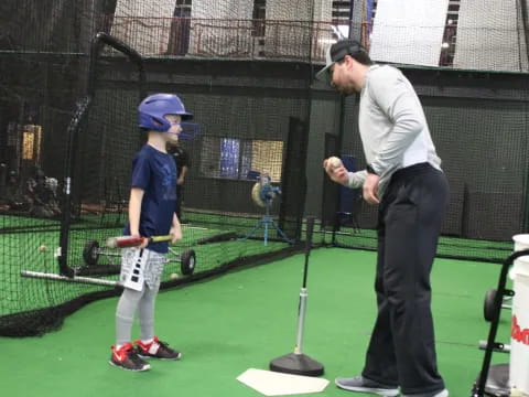 a person and a boy playing baseball