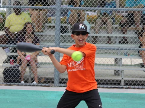 a person hitting a ball with a baseball bat