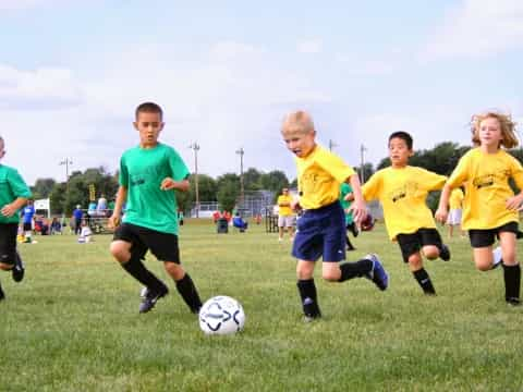 a group of kids playing football