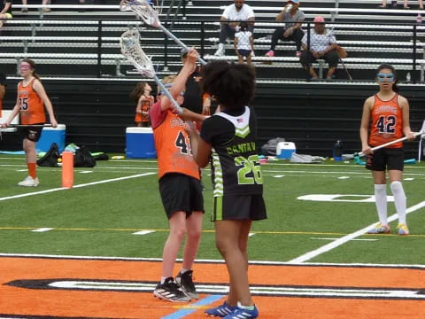 a group of women playing lacrosse