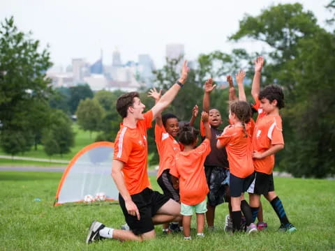 a group of boys in orange shirts