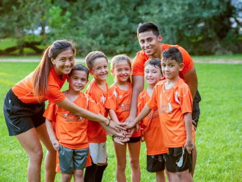 a group of people wearing orange shirts