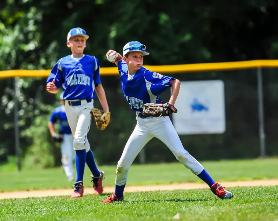 a couple of young boys playing baseball