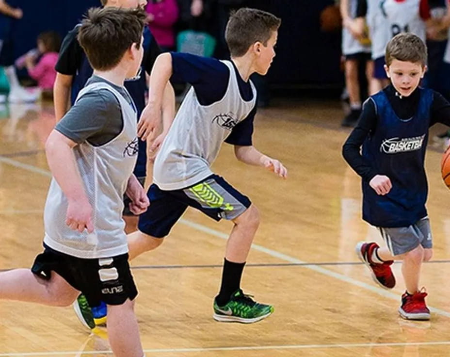 a group of boys playing basketball