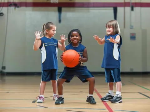 a group of kids playing basketball