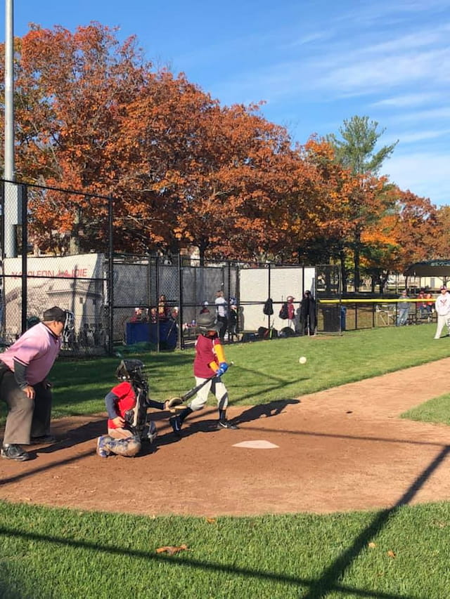 a group of people playing baseball