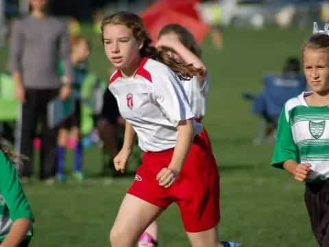 a group of girls running on a field