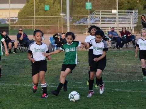 girls playing football on a field