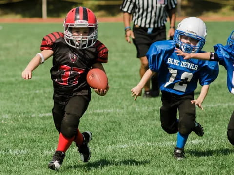 a group of kids playing football