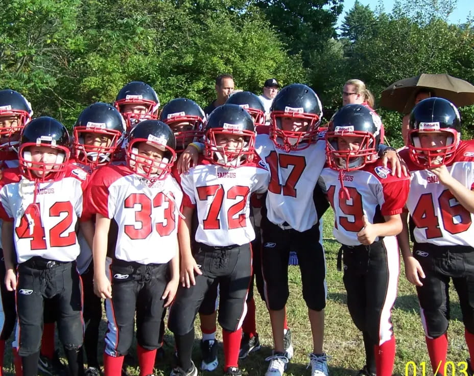 a group of kids wearing football gear