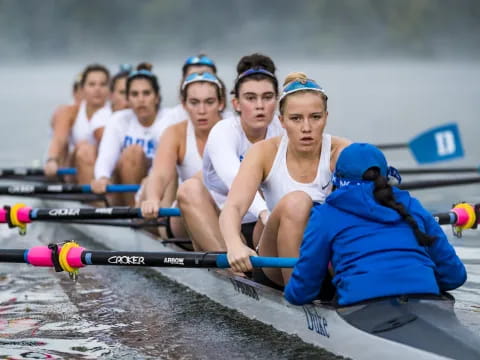 a group of women rowing a boat
