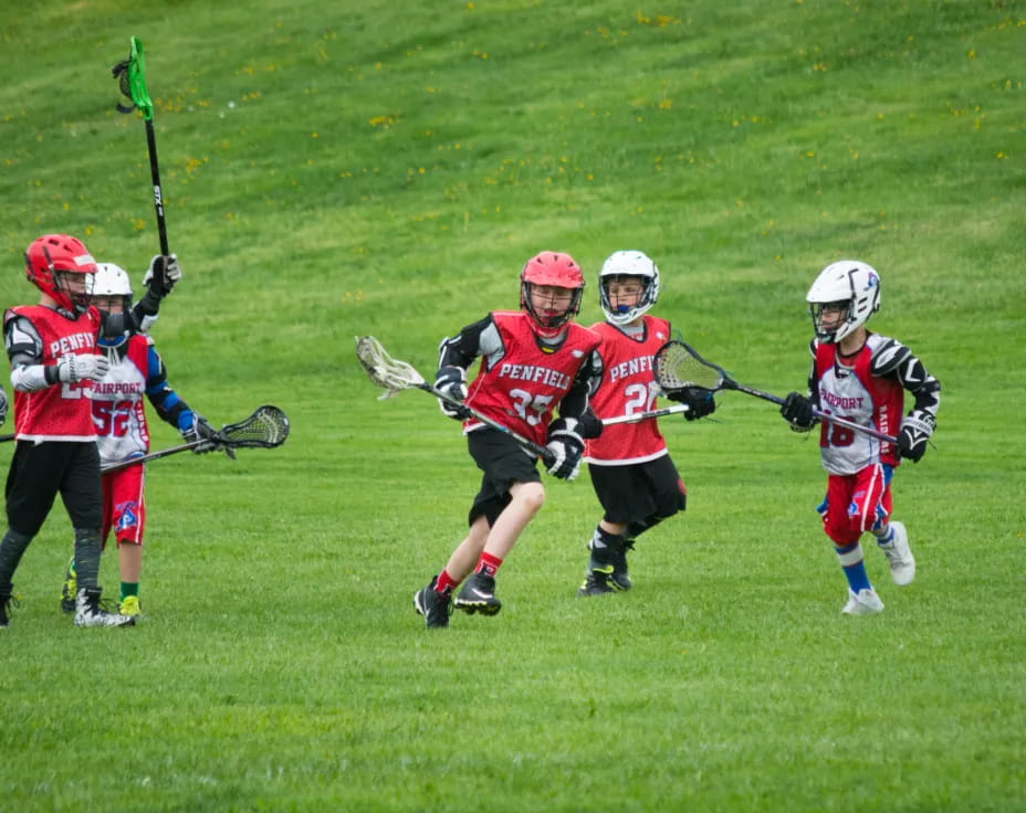 a group of people playing lacrosse