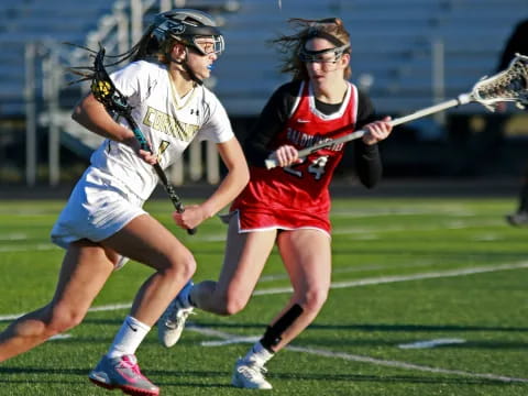 women playing lacrosse on a field