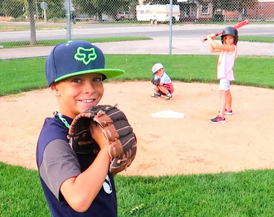 a kid in a baseball uniform