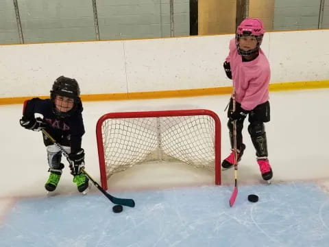 kids playing hockey on ice