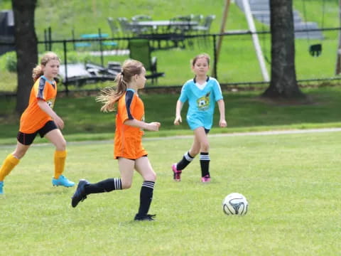 girls playing football on a field