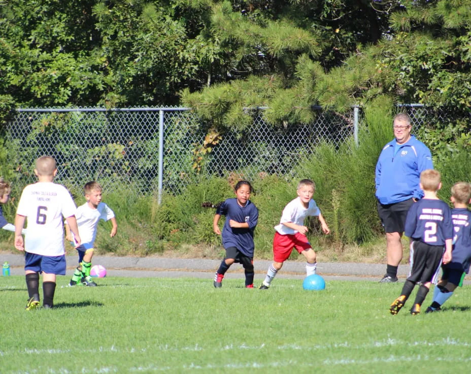 a group of kids playing football