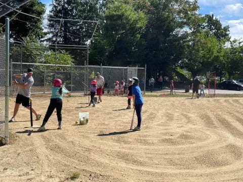 a group of people playing baseball