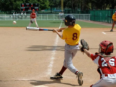 a baseball player hitting a ball with a bat