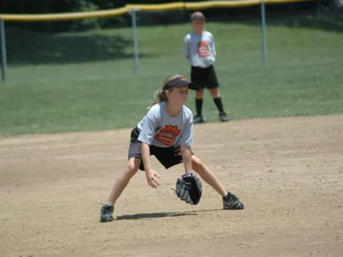 a girl catching a baseball