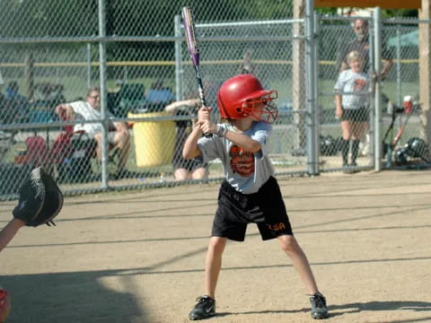 a kid swinging a baseball bat