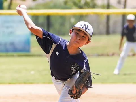 a young boy throwing a baseball