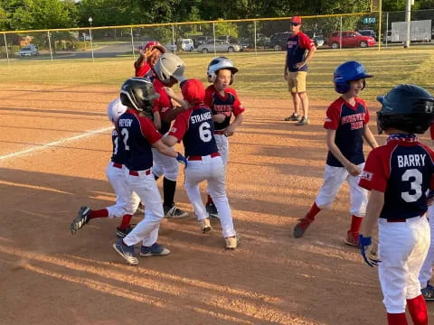 a group of kids playing baseball