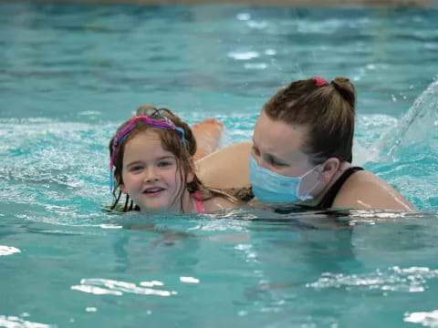 a person and a child swimming in water